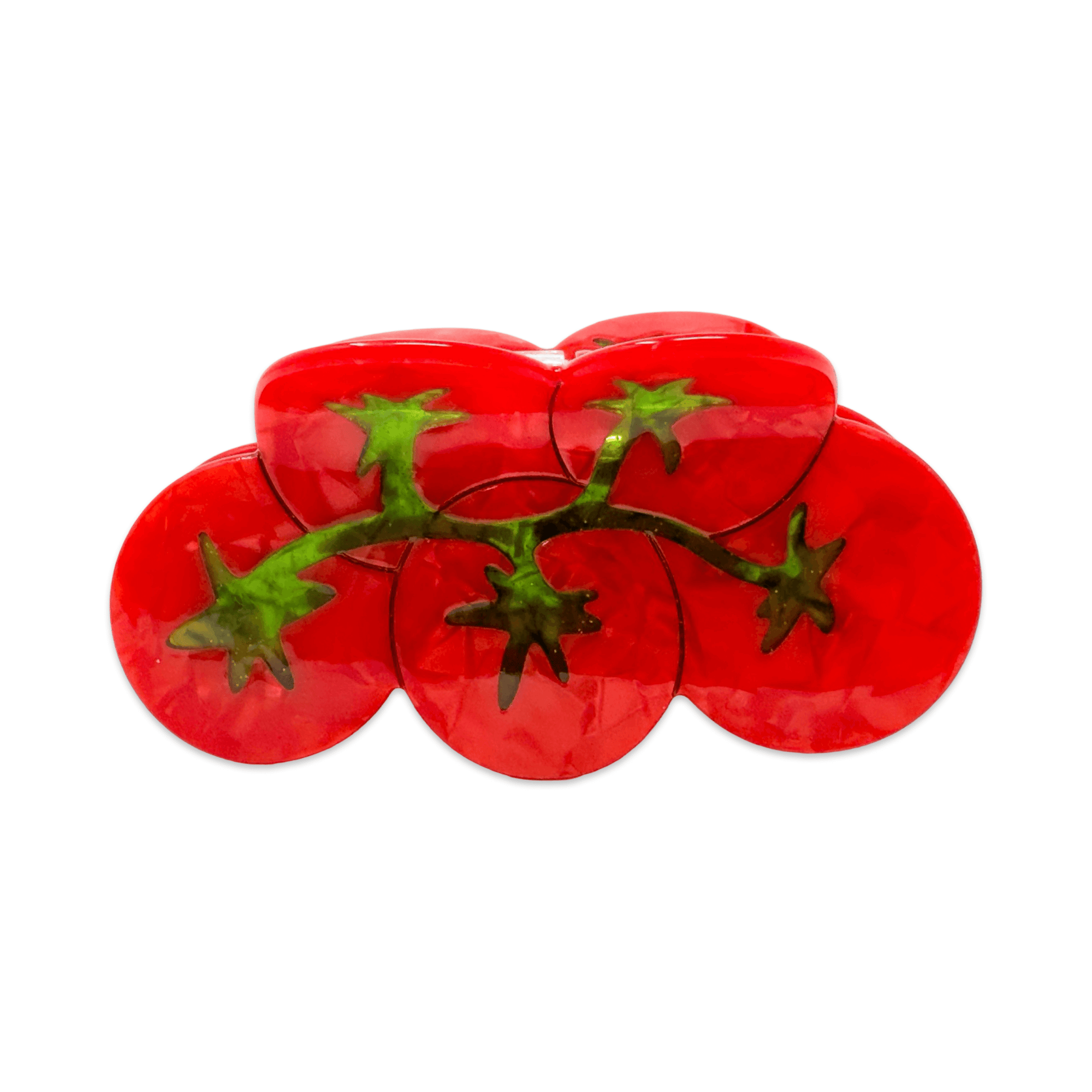 Red tomato-shaped hair claw with green stems on a white background