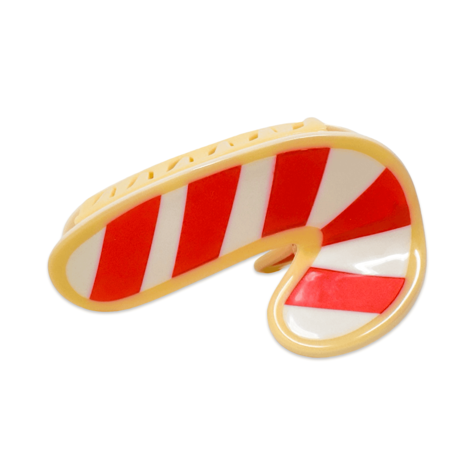 Candy cane-shaped cookie hair claw on a white background