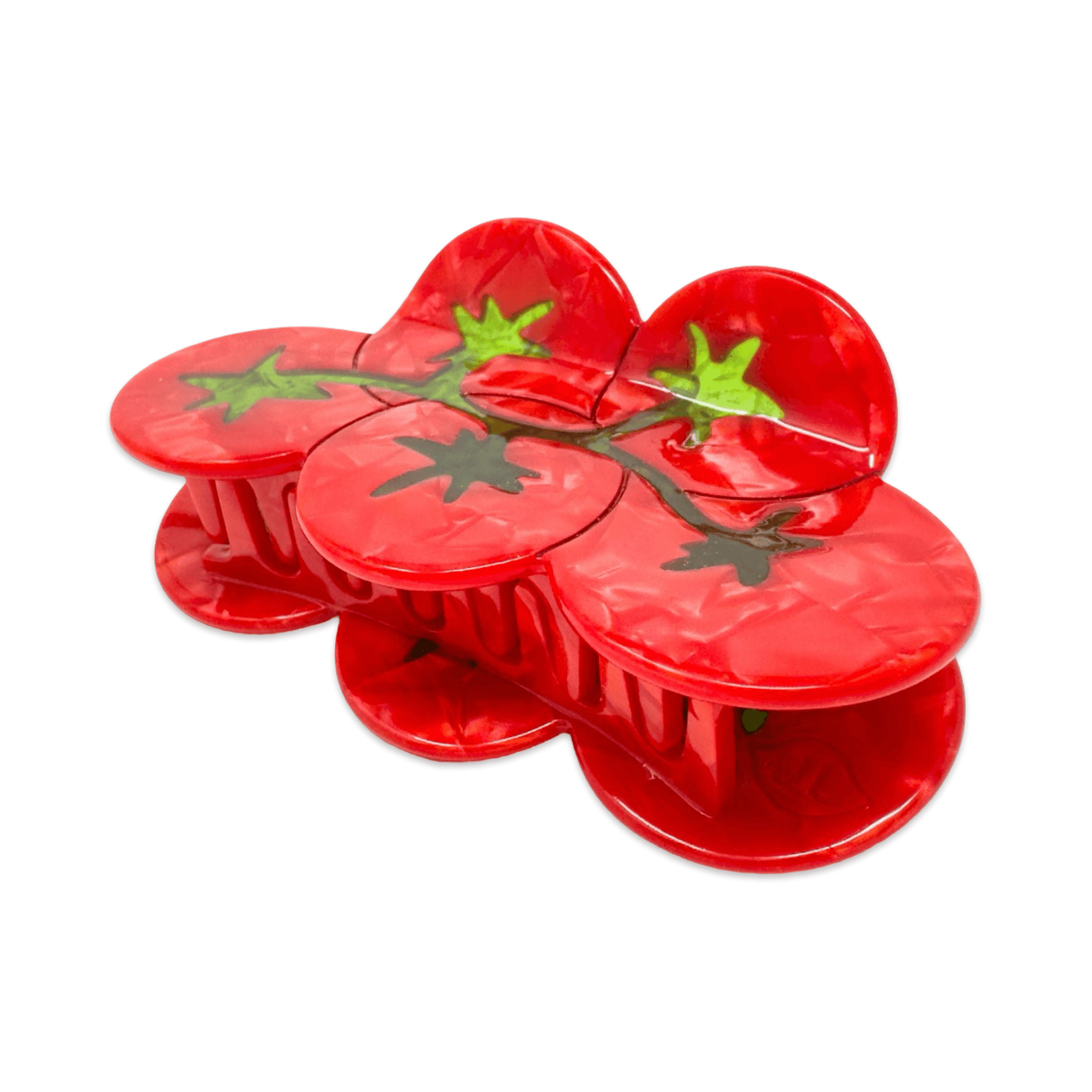 Red plastic tomato-shaped hair claw on a white background