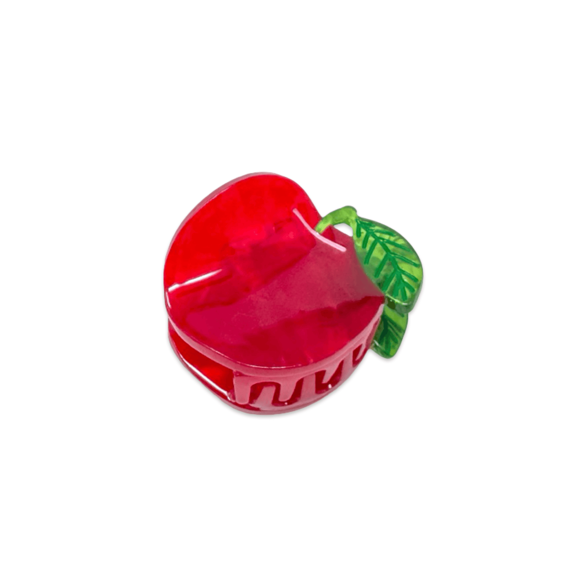 Red apple-shaped hair claw with a green leaf on a white background